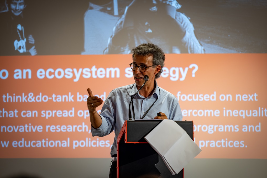 Ismael Palacin stands behind the podium delivering his keynote address at OTT Conference 2024